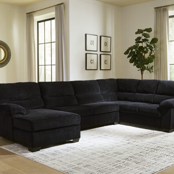 Mustast velvetist nurgadiivan SimpleJoy kaasaegses elutoas